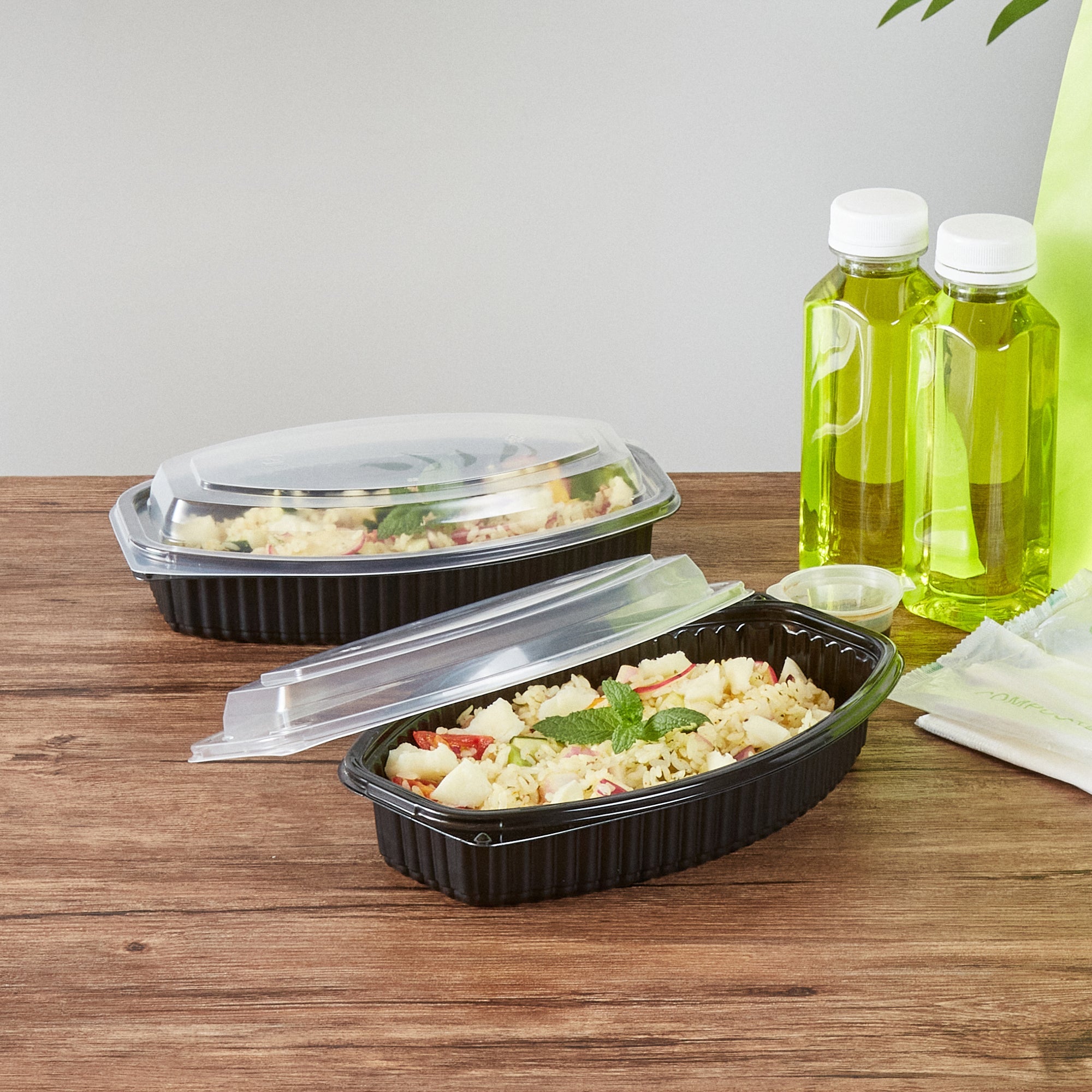 Chef 101 24 oz Oval Black Plastic Food Container - with Clear Lid, Microwavable - 9 1/4" x 5 3/4" x 2 1/2" - 100 count box