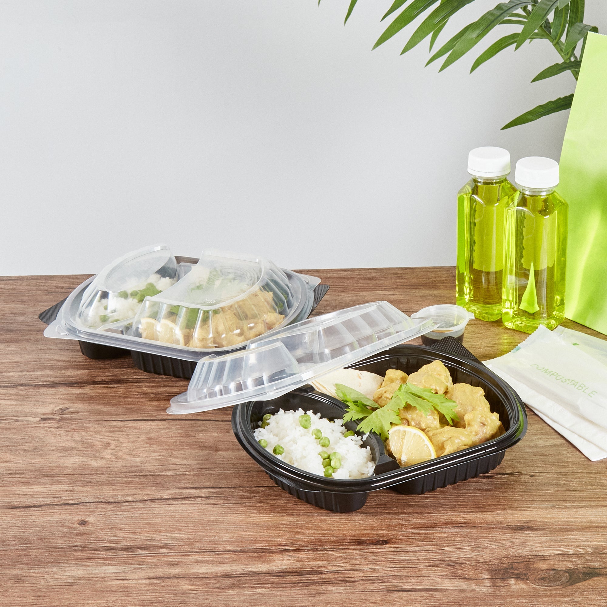 Chef 101 28 oz Oval Black Plastic Food Container - with Clear Lid, 2 Compartments, Microwavable - 9 1/2" x 8" x 2 3/4" - 50 count box