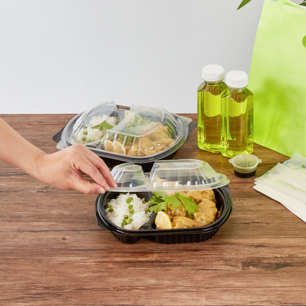 Chef 101 28 oz Oval Black Plastic Food Container - with Clear Lid, 2 Compartments, Microwavable - 9 1/2" x 8" x 2 3/4" - 50 count box